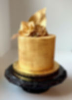 Metallic gold cake with gold fondant florals