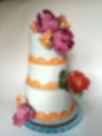 White wedding cake & vibrant florals